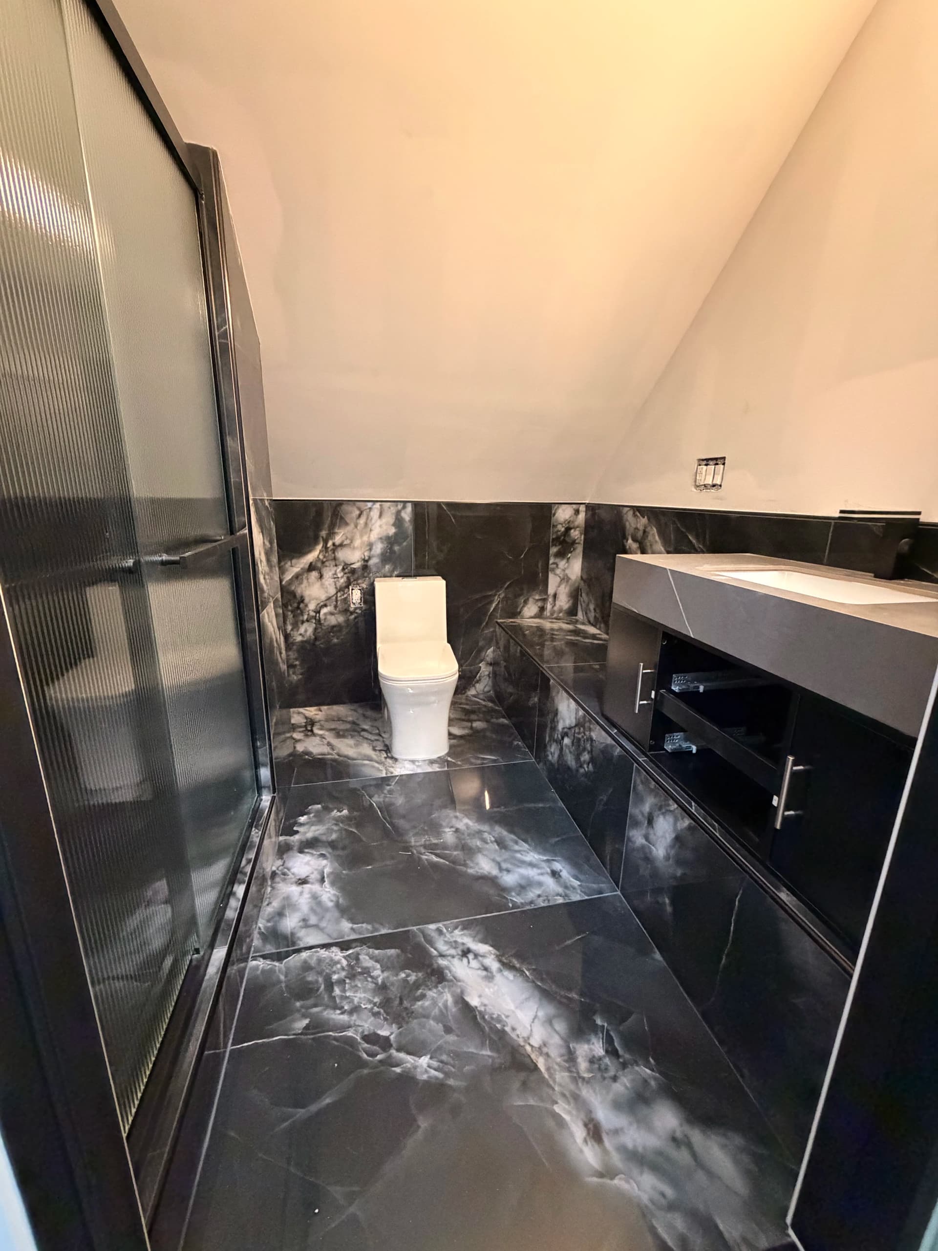 South Windsor Bathroom Remodel with Dark Marble Tile and Custom Shower image